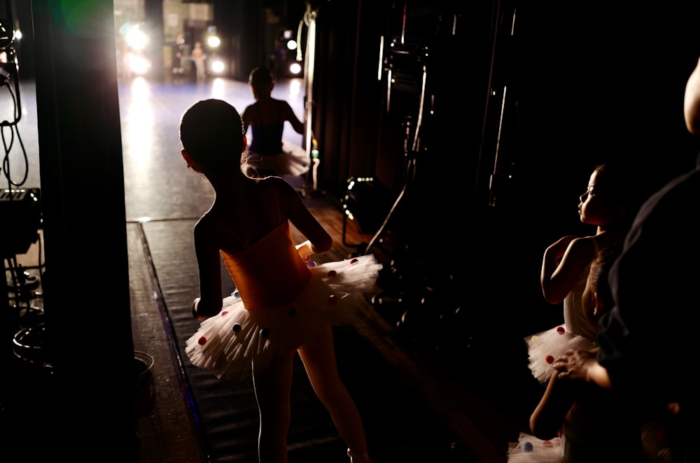 woman in white dress walking on sidewalk during night time