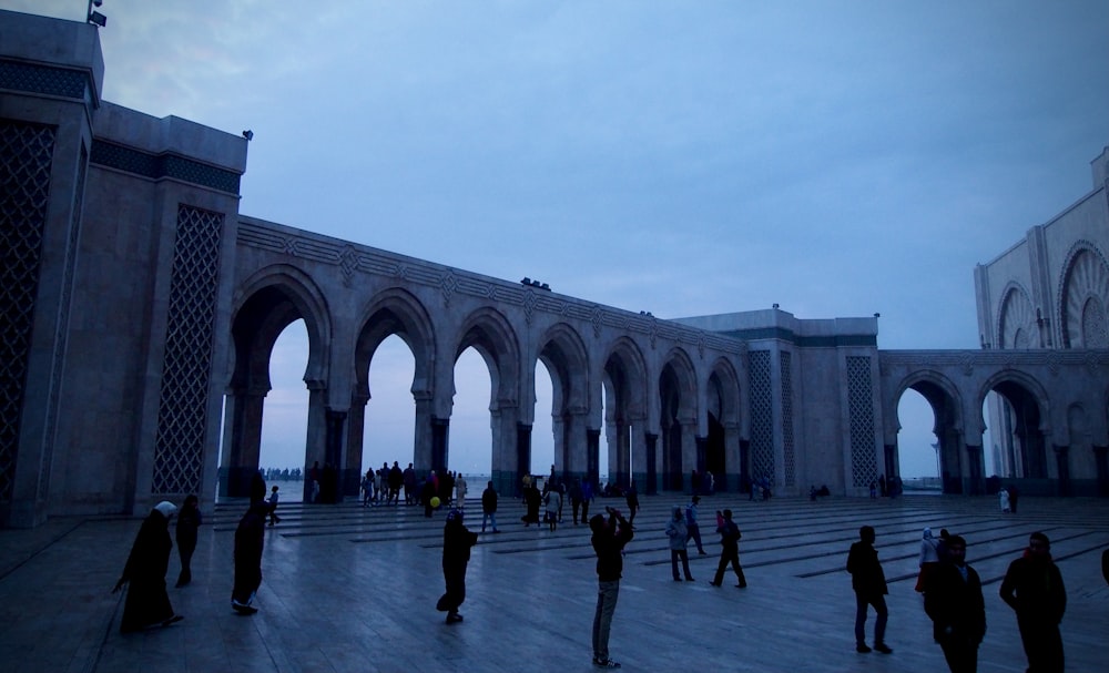 people walking on gray concrete bridge during daytime