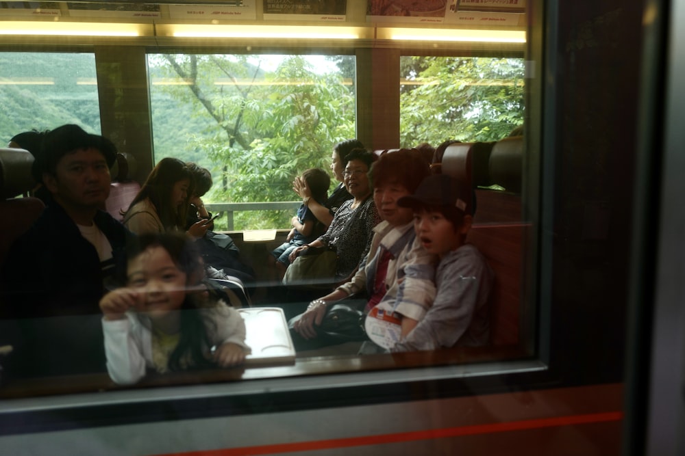 people sitting on red and white bench