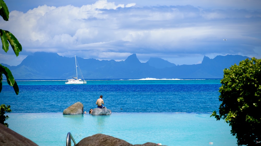 white sail boat on sea during daytime