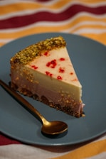 A close-up of a creamy, gluten-free cheesecake slice with fresh berries on top.
