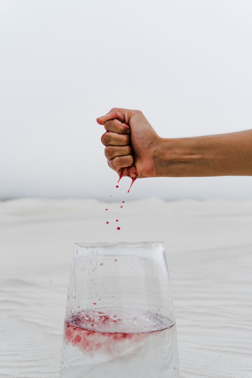 person holding clear drinking glass