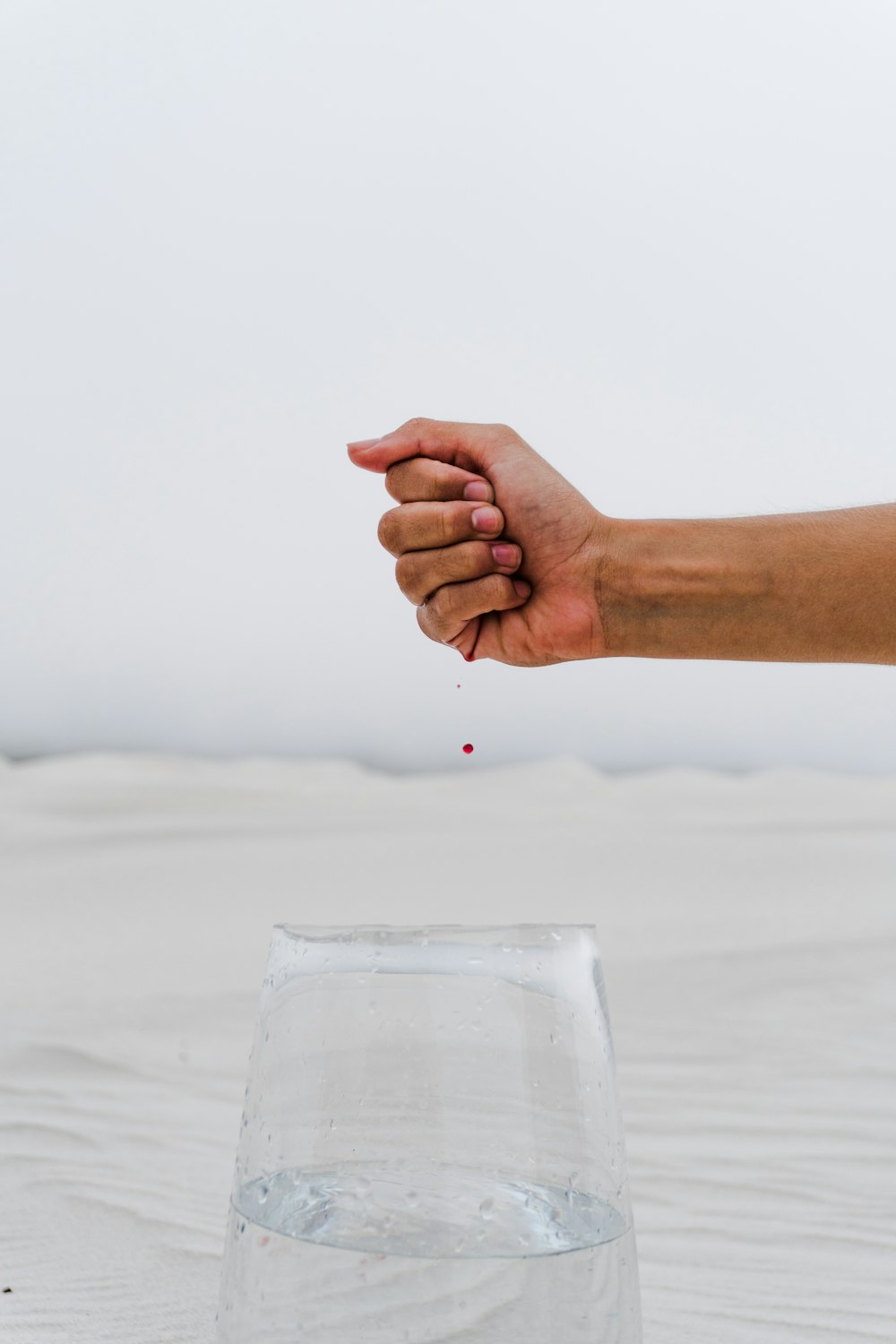 person holding clear drinking glass