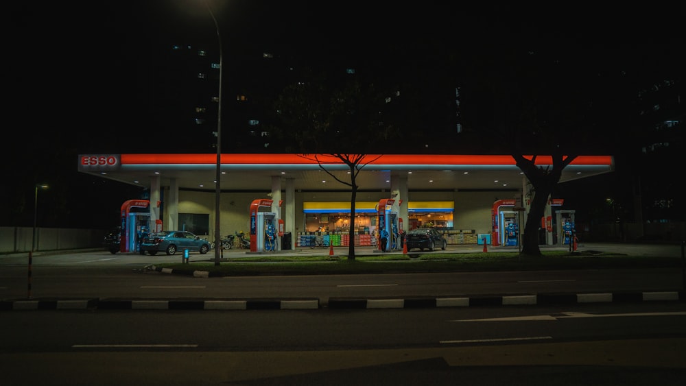 cars parked in front of store during night time