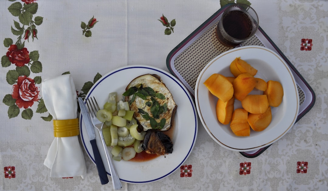 sliced fruits on white ceramic plate, Set table with fruit and vegetable. Healthy Italian Sicilian dinner