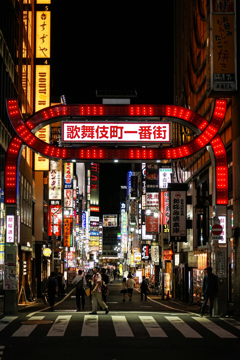 people walking on street during nighttime