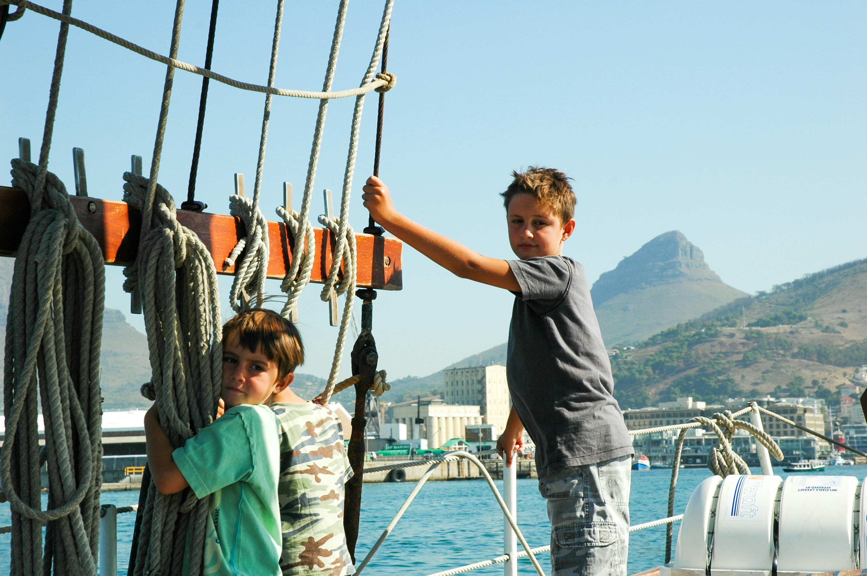 man in black crew neck t-shirt standing beside girl in green jacket during daytime