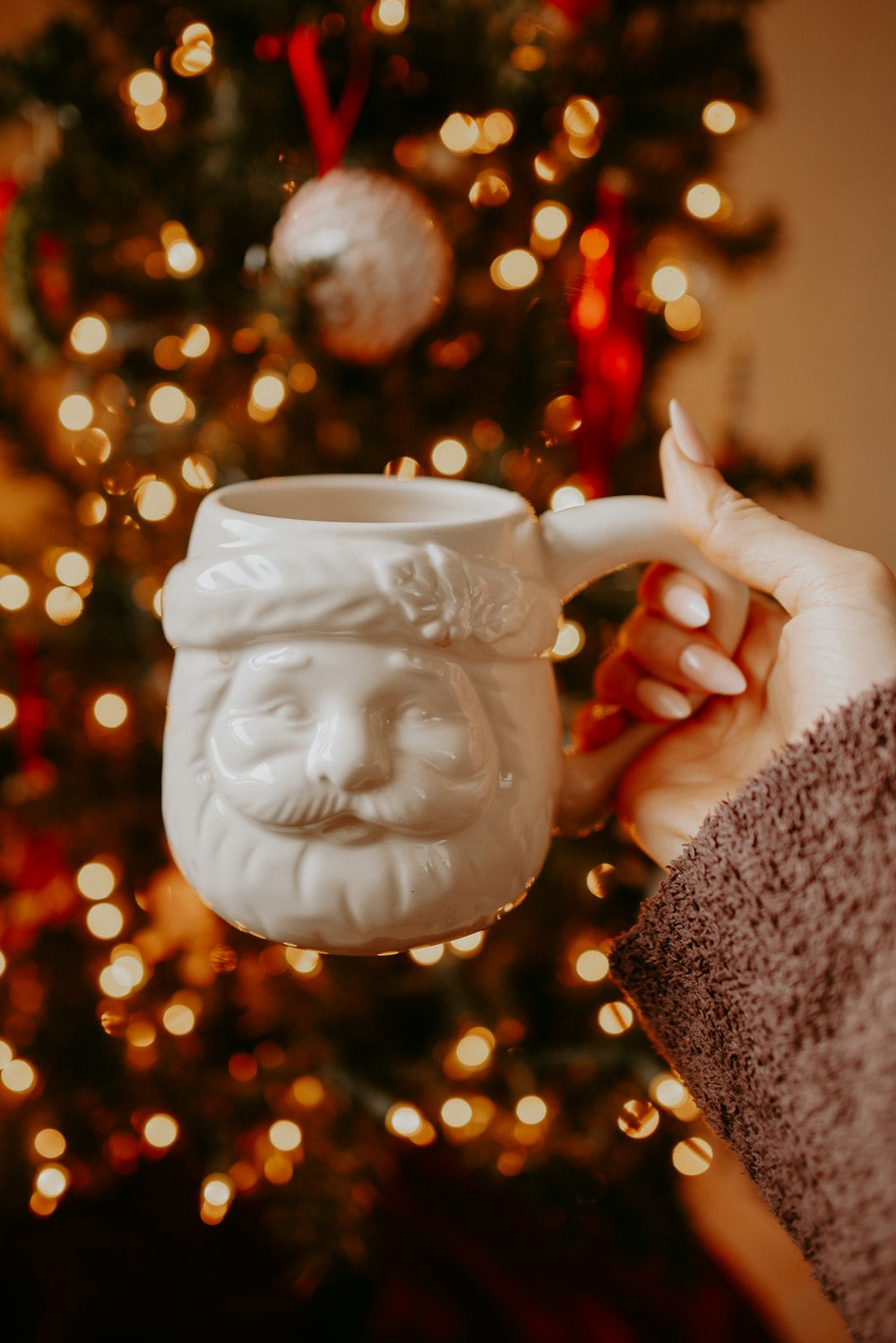 person holding white ceramic mug