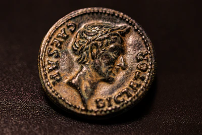 Close-up of a weathered Roman denarius showing intricate emperor profile.