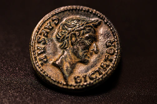 Close-up of an ancient Roman coin showing detailed engravings and patina.
