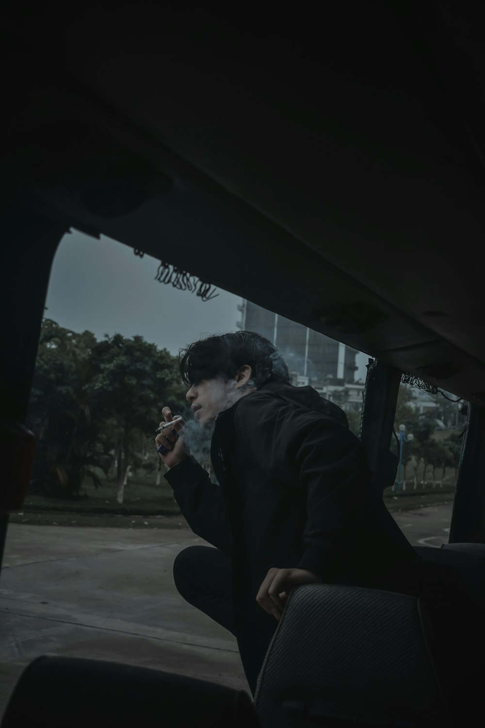 man in black jacket sitting on chair