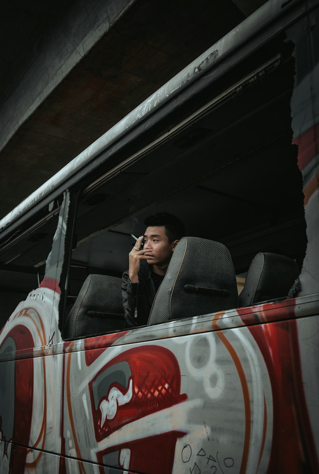 man in black suit sitting on car seat