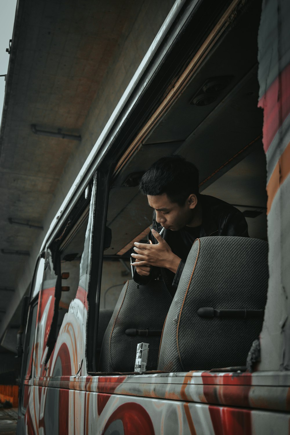 man in black jacket sitting on car seat