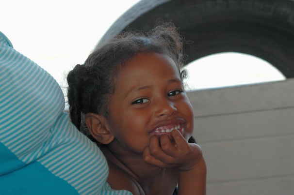 A smiling adolescent engaged in a supportive conversation with a caring therapist.