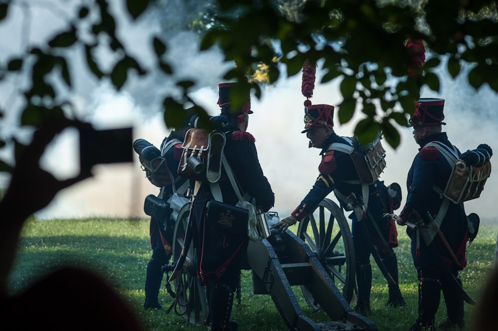 Hombres en uniforme blanco y negro de pie en un campo de hierba verde durante el día