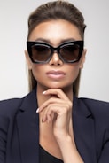woman in black suit wearing black sunglasses