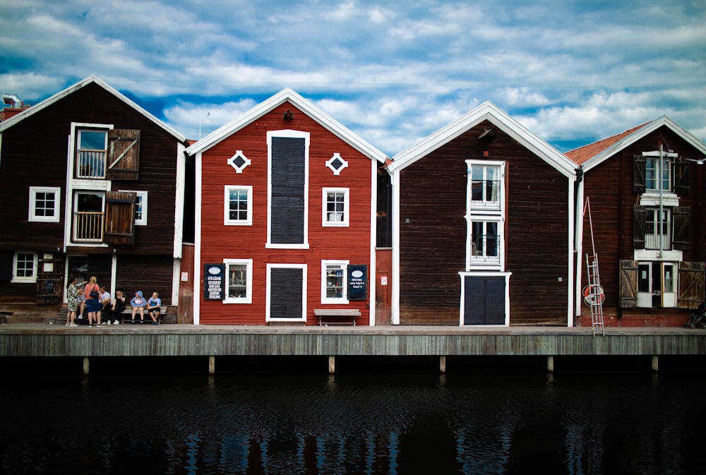 red and white concrete house beside body of water during daytime