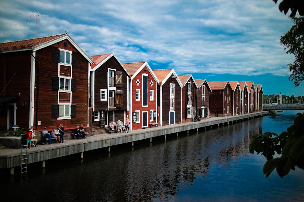 red and white wooden houses beside river during daytime