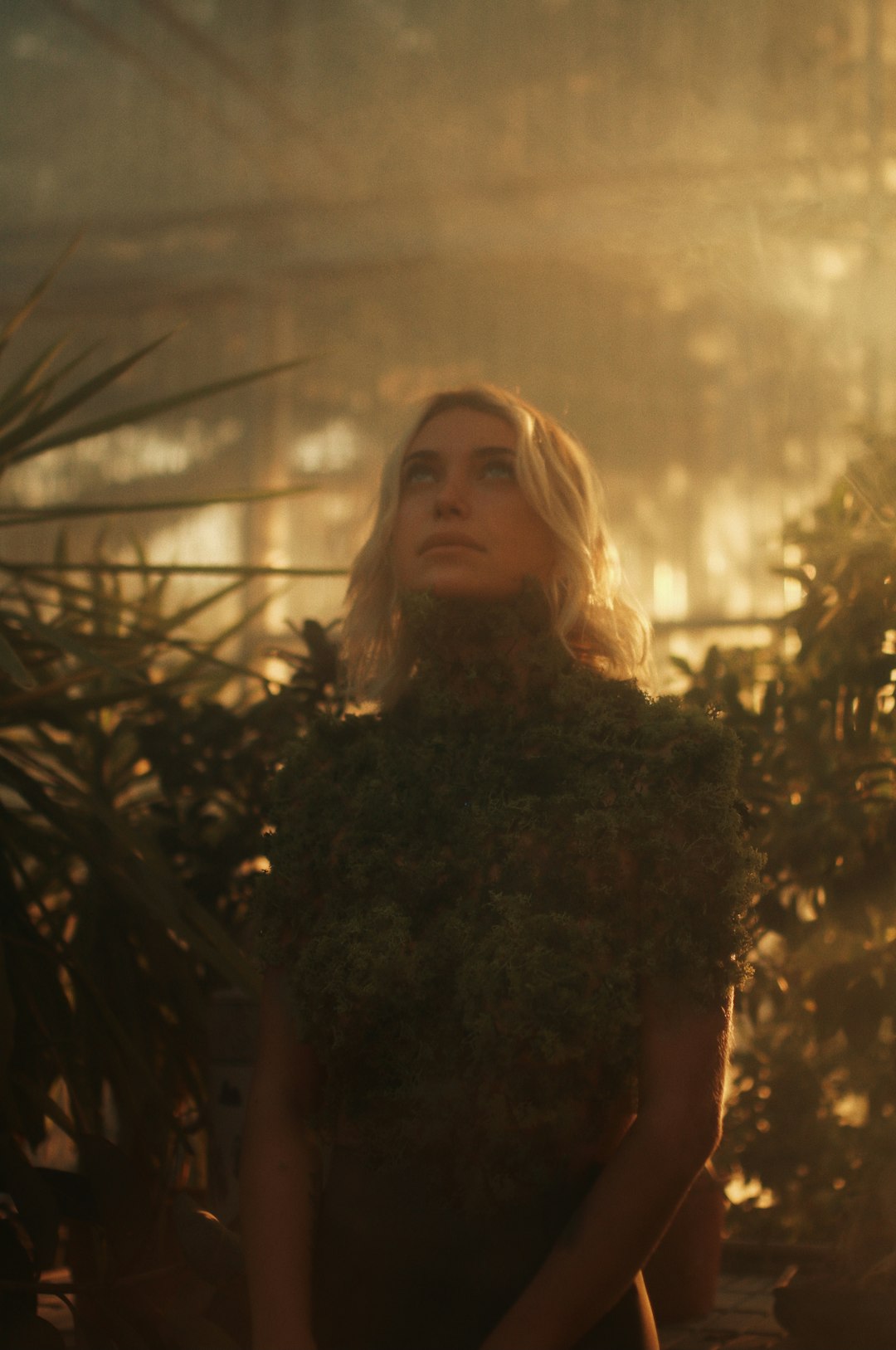 woman in black shirt standing near green plants