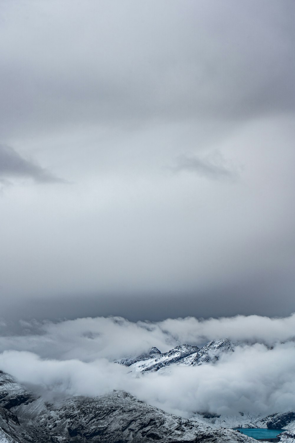 a view of a mountain range covered in clouds