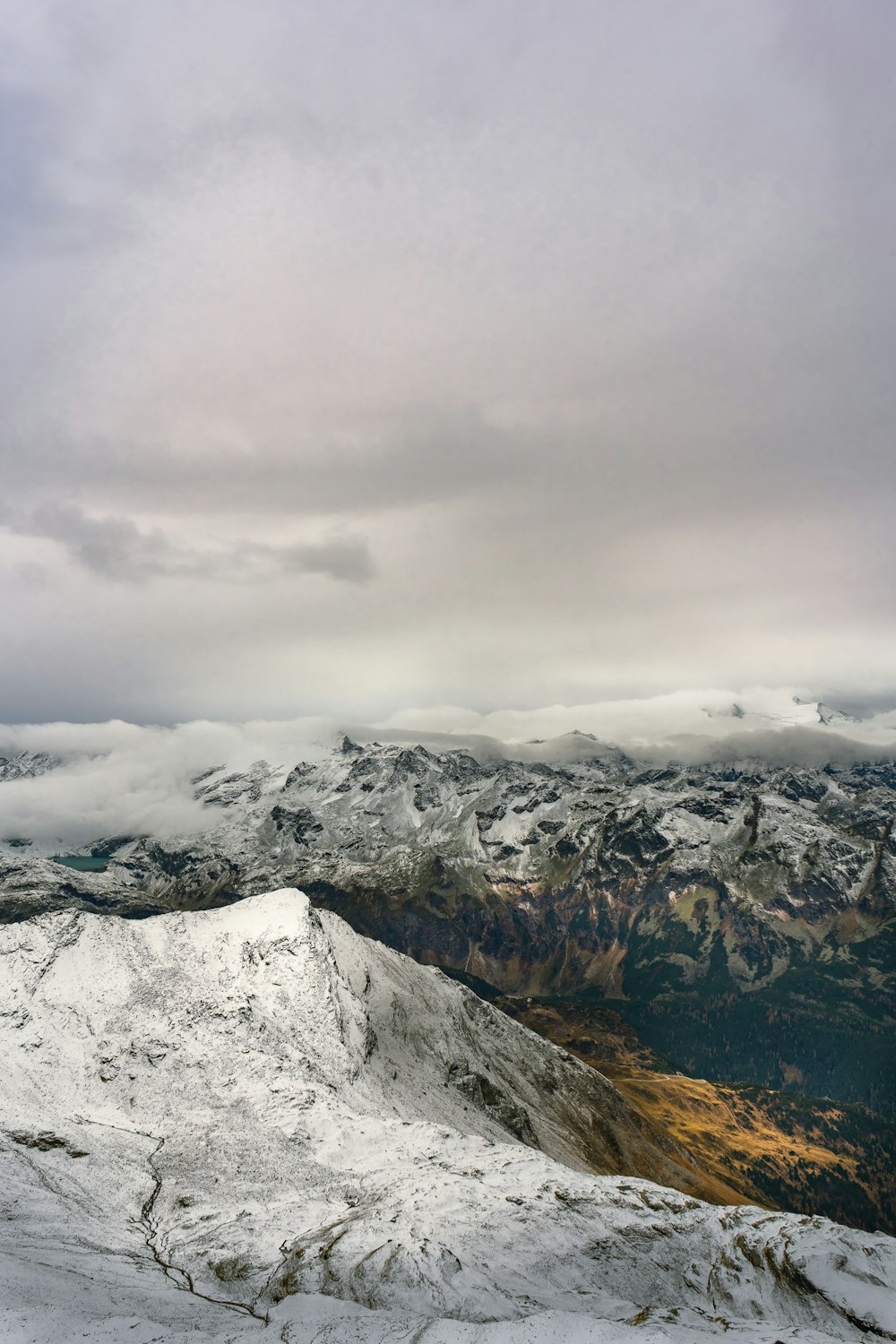 snow covered mountain under cloudy sky during daytime