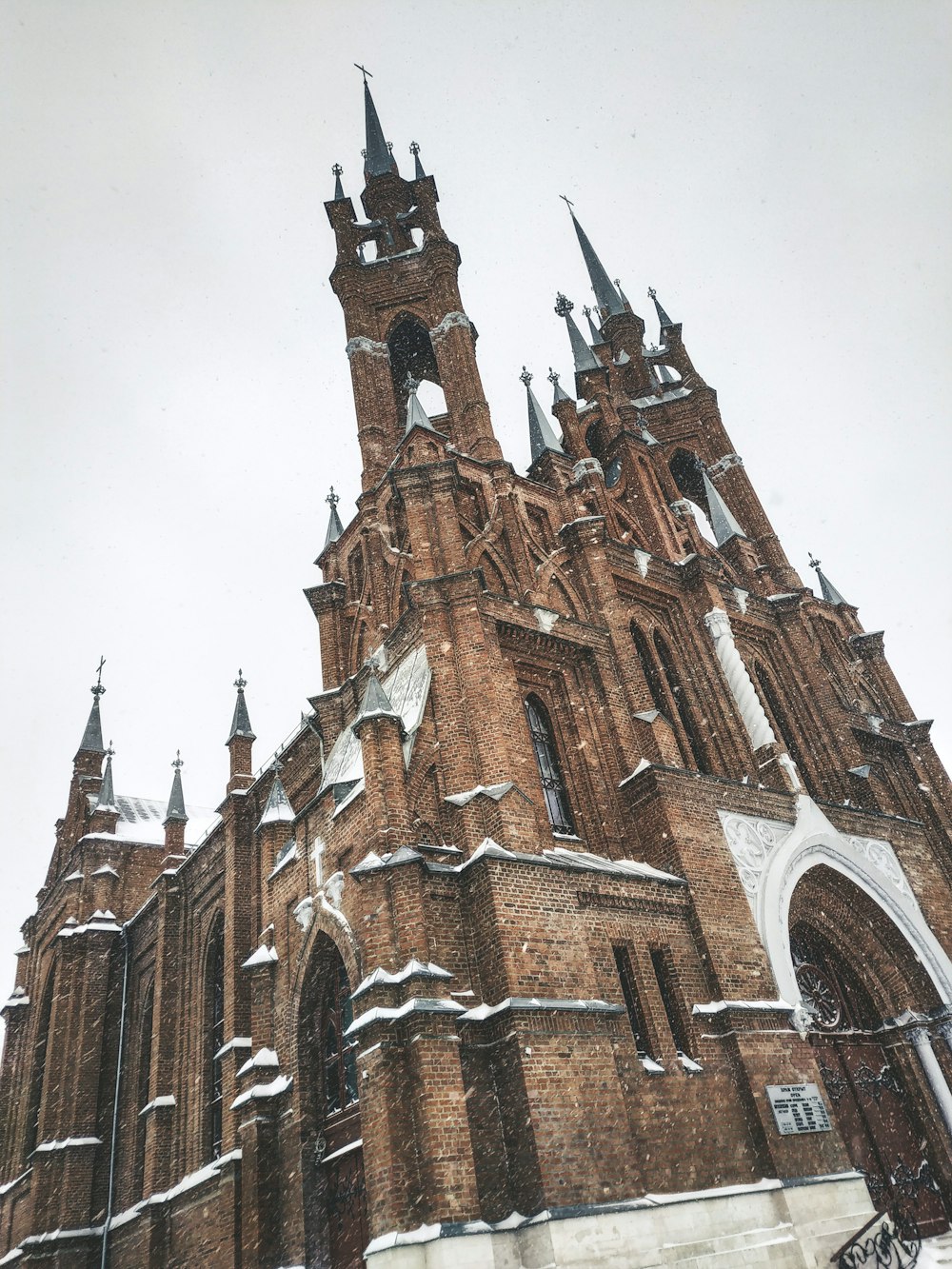 a very tall church with a clock on it's side