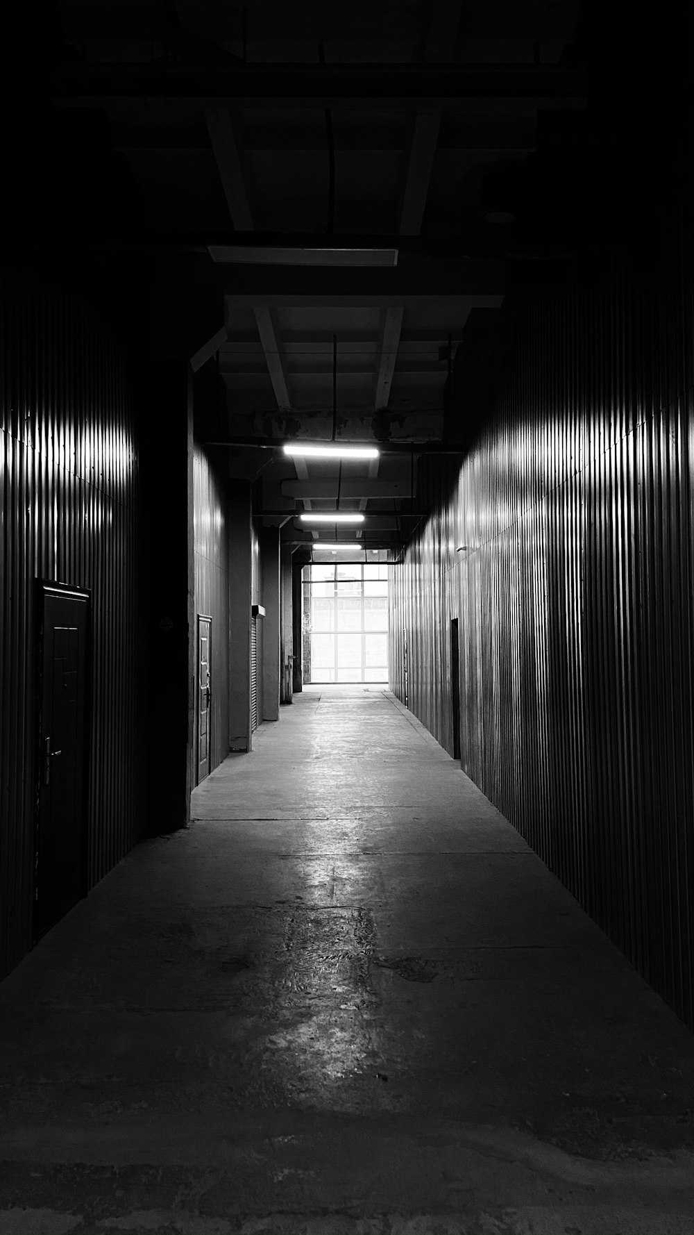 grayscale photo of hallway with lights