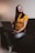 A woman using a laptop with a satisfied expression.