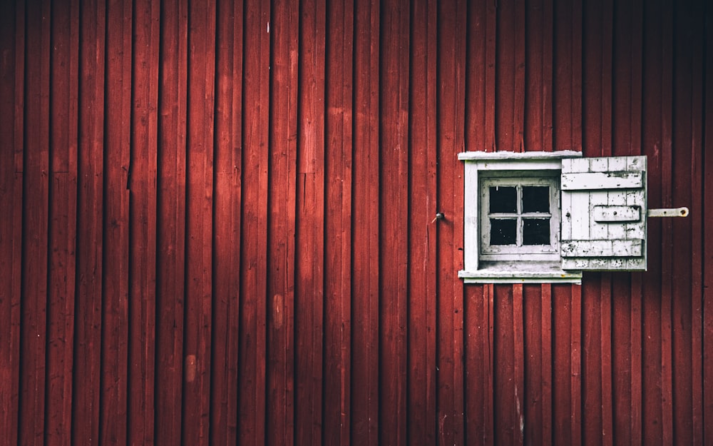 a red wall with a window on it