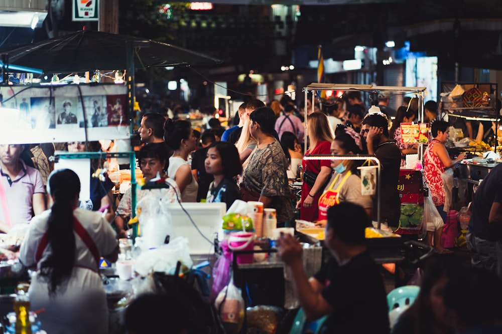 people sitting on chair in front of table with food on top