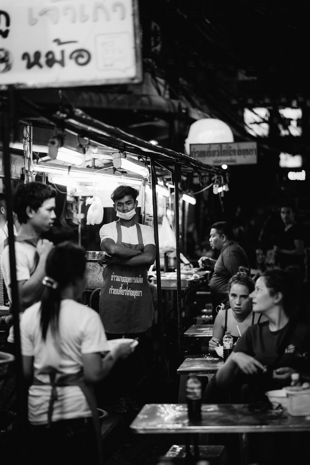 grayscale photo of people in a restaurant
