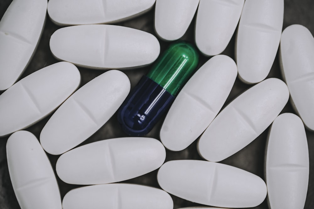 white and green medication pill