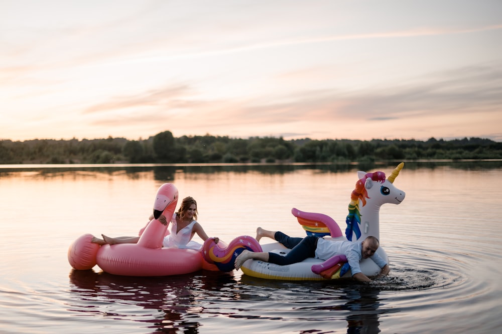 people riding on inflatable boat on lake during daytime