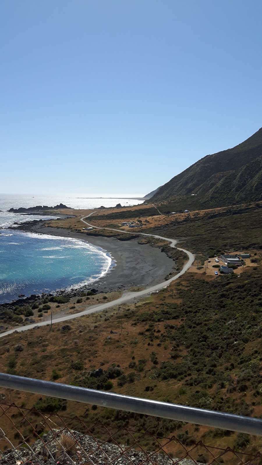 Scenic coastal road with turquoise ocean and white sand beach