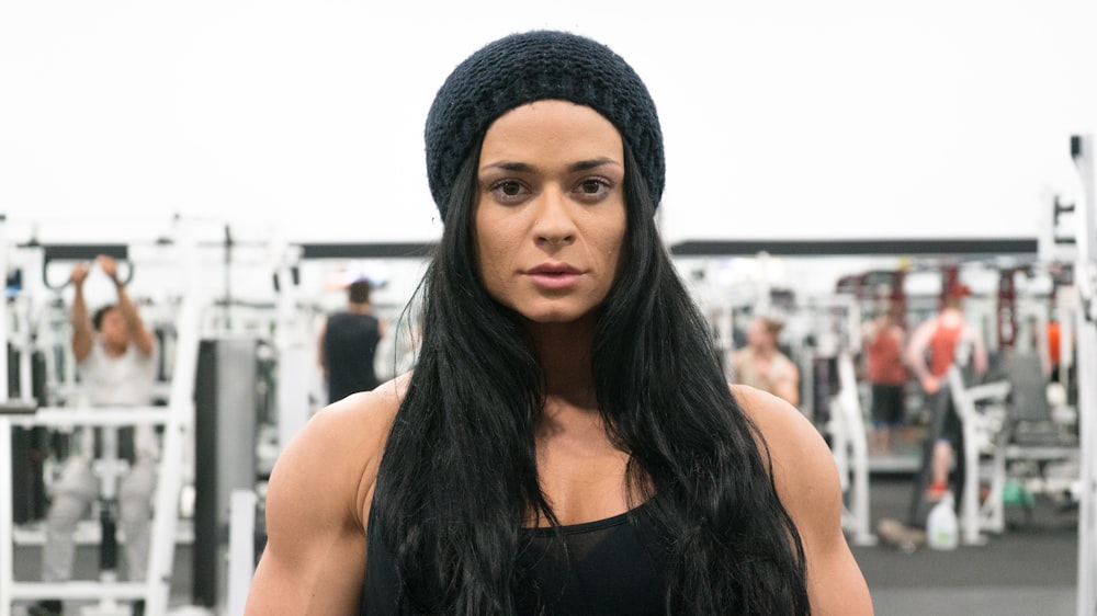 woman in black tank top wearing black knit cap