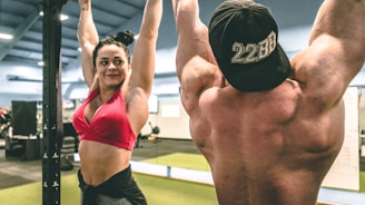 woman in red sports bra and black shorts doing yoga