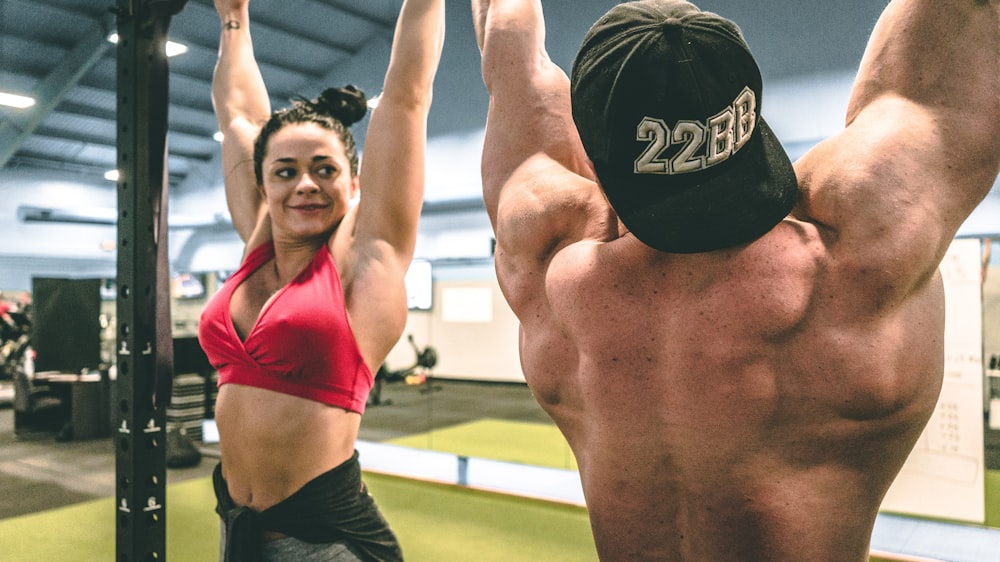 woman in red sports bra and black shorts doing yoga