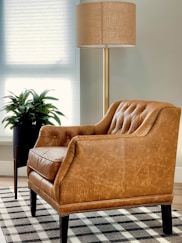 brown sofa chair near window