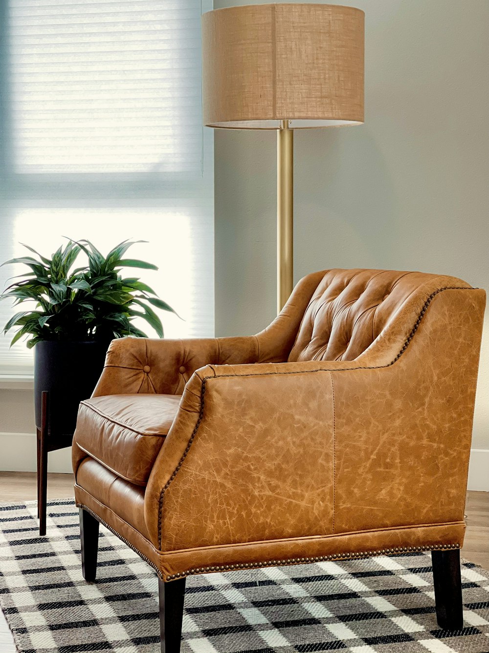 brown sofa chair near window