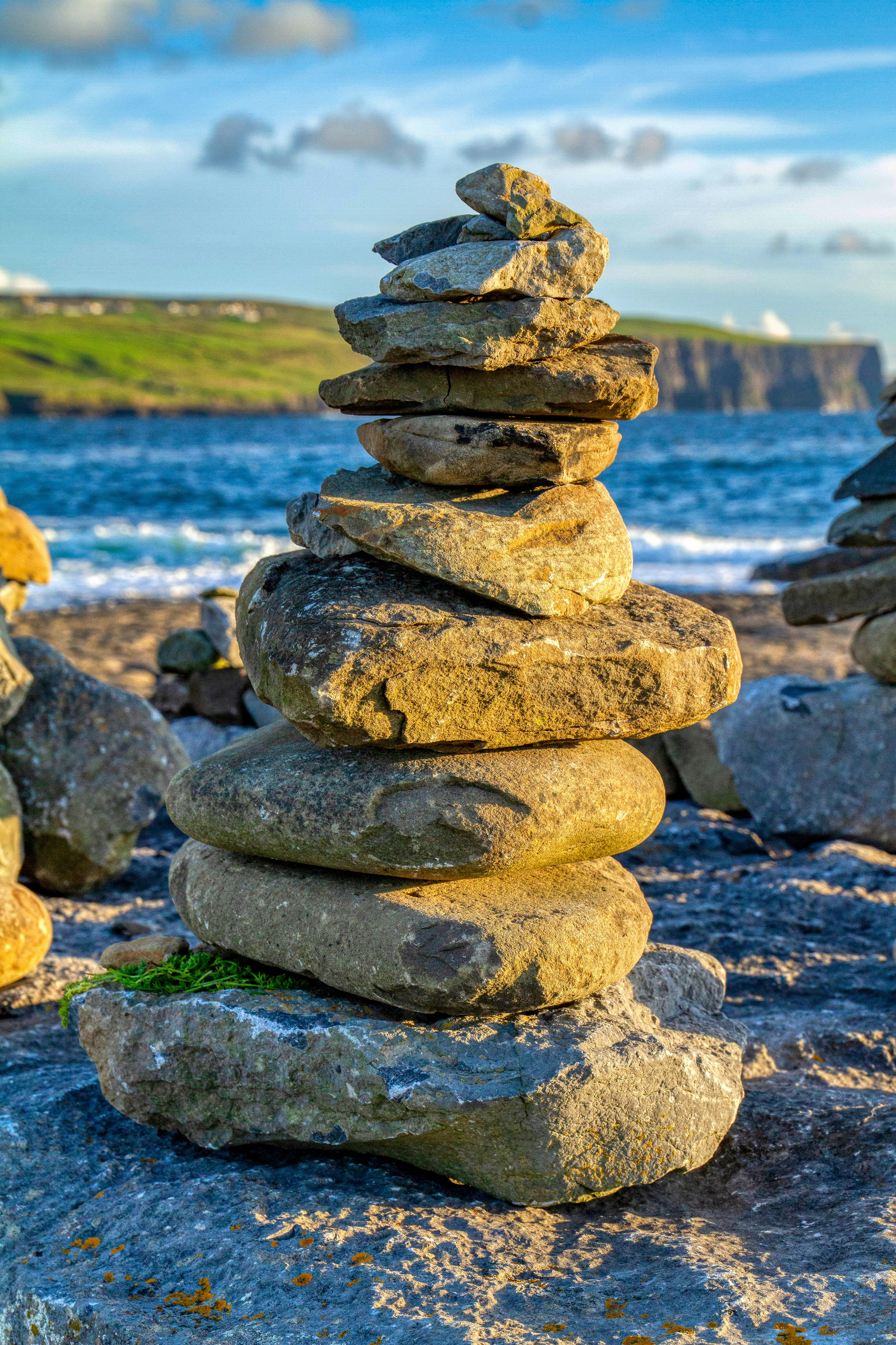 stack of stones near body of water during daytime