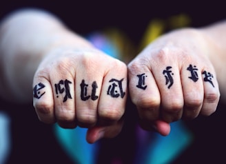 persons hand with black tattoo