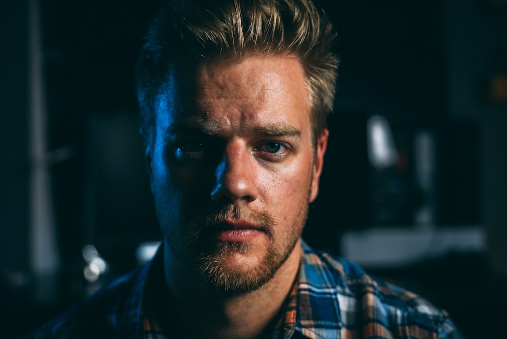 man in blue white and red plaid button up shirt