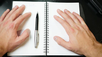 silver and black click pen on white notebook