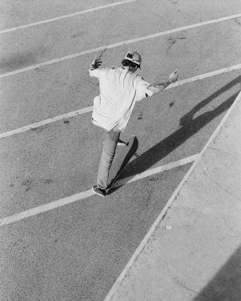 man in white shirt and pants walking on the street