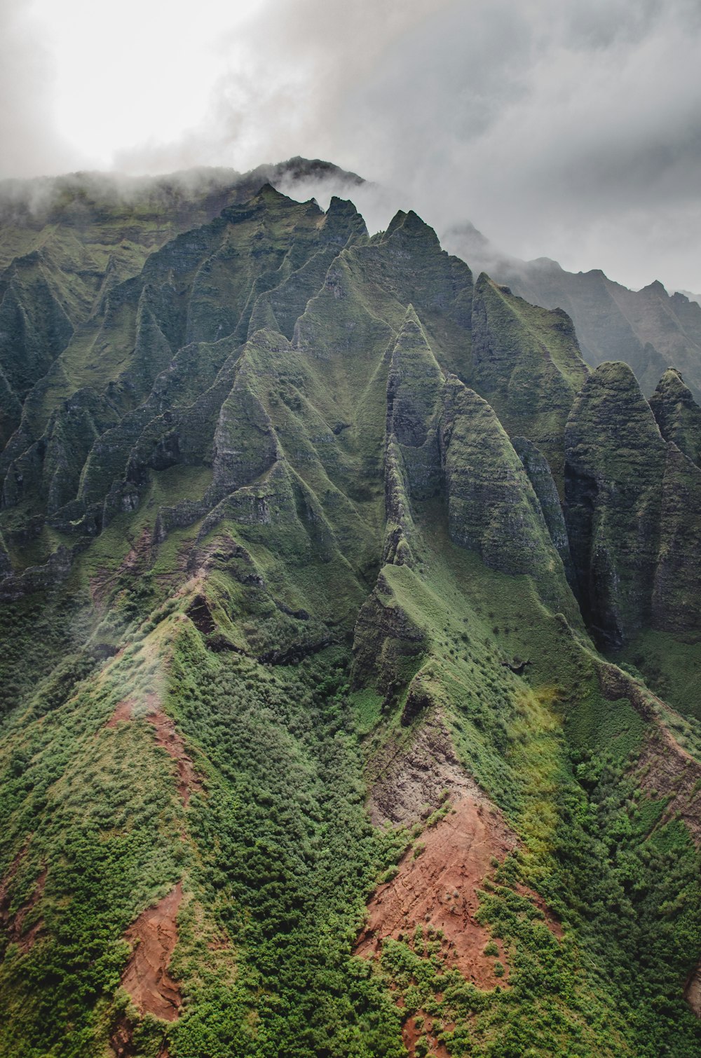 green and brown mountain under cloudy sky during daytime