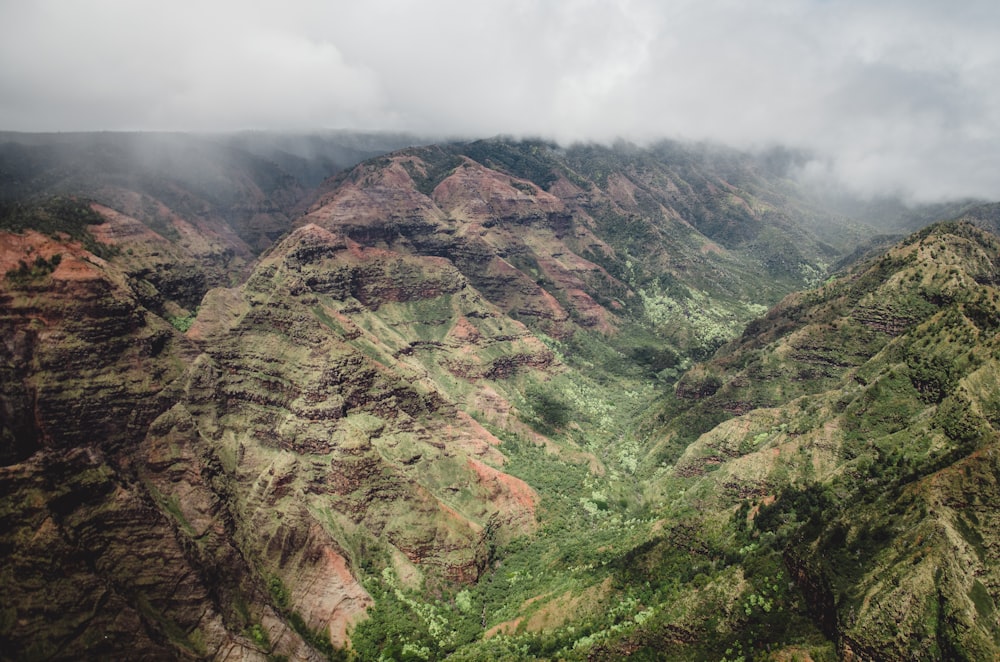 green and brown mountains under white clouds during daytime