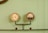 A pair of vintage-style gauges attached to a metal pipe system against a pale green background. The left gauge appears to be a pressure meter, while the right one displays increments and some text, likely indicating measurements.