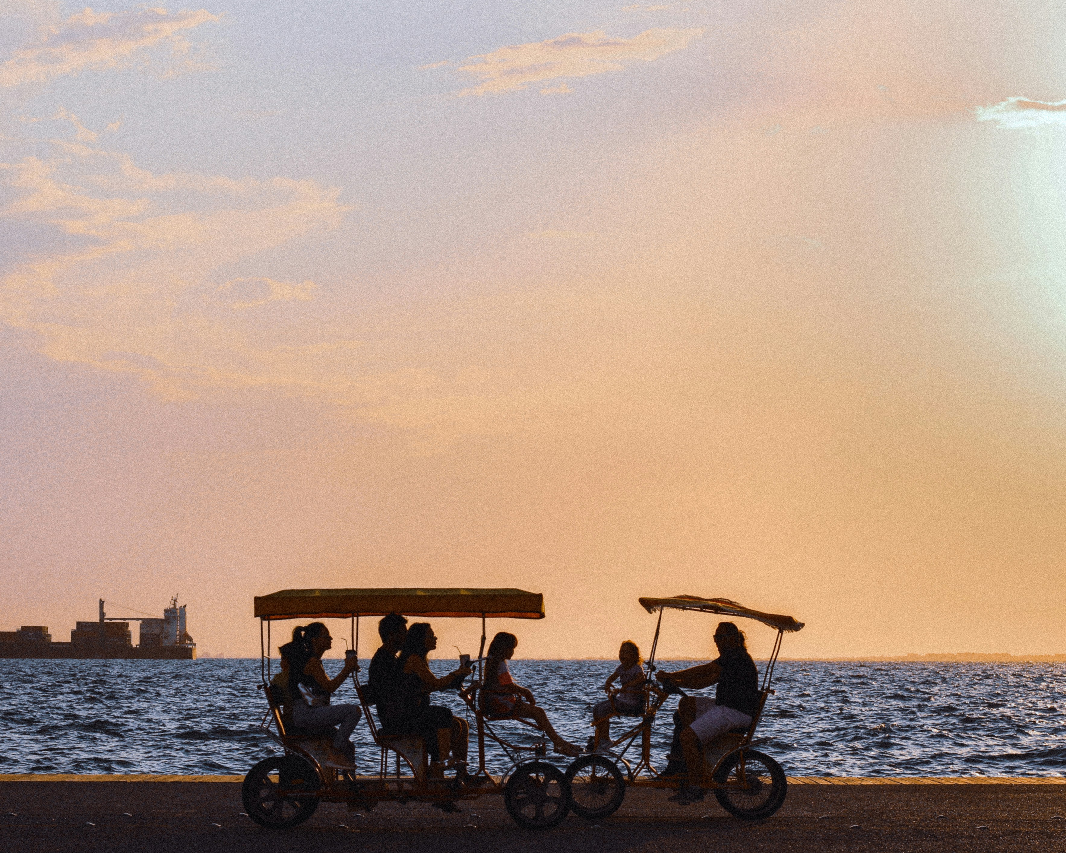 people riding on a boat on a lake during sunset