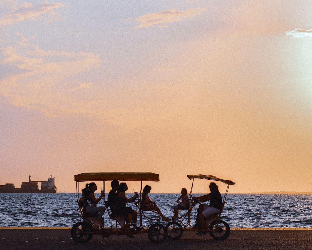 people riding on a boat on a lake during sunset