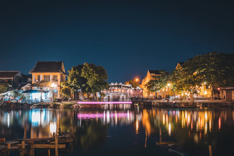 Brown and white house near body of water during night time